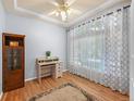 Comfortable office with hardwood floors, a decorative ceiling fan, and a built-in bookcase for storage at 19118 E Grand Cir, Aurora, CO 80015