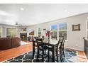 Well-lit dining room area with views to the living room fireplace and a large window at 6174 Flattop St, Golden, CO 80403