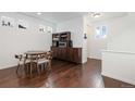 Small dining area with dark wood floors and a built-in hutch at 5480 Danube St, Denver, CO 80249