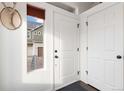 Bright entryway with white door and coat closet at 5480 Danube St, Denver, CO 80249