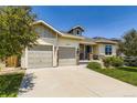 Inviting front exterior of a home with a well-kept lawn and two-car garage at 21855 E Idyllwilde Dr, Parker, CO 80138