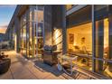 Spacious balcony with outdoor seating, a grill, and a peek into a beautifully lit bedroom through expansive windows at 55 W 12Th Ave # 608, Denver, CO 80204