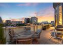 Outdoor balcony with comfortable seating, grill, and views of the city skyline, perfect for relaxing and entertaining at 55 W 12Th Ave # 608, Denver, CO 80204