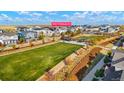 Aerial view of community featuring a large grassy field, walking paths, and well-maintained landscaping at 6041 N Orleans St, Aurora, CO 80019
