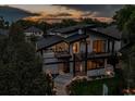 Eye-catching modern home featuring unique architectural design, large windows, and manicured front yard landscaping at 1175 S Jackson St, Denver, CO 80210