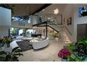 Bright, open-concept living area with soaring ceilings, modern staircase, and ample natural light at 1175 S Jackson St, Denver, CO 80210
