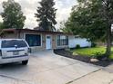 A single-story home with a well-maintained front yard and a driveway at 6139 Broadway S, Littleton, CO 80121