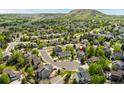 A lovely aerial view showcasing this home's neighborhood location near open space and a hill at 1825 Cooper Ct, Castle Rock, CO 80109