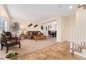 A welcoming living room and stairs featuring neutral carpet and tile floors, and an open floor plan at 1825 Cooper Ct, Castle Rock, CO 80109