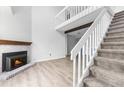 Bright living room with a fireplace, staircase and second floor balcony at 1740 S Ammons St # C, Lakewood, CO 80232