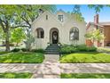 Attractive stucco home, featuring a classic design and lush green lawn at 595 S Race St, Denver, CO 80209