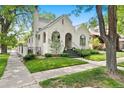 Beautiful stucco home with arched entryway and well-maintained landscaping at 595 S Race St, Denver, CO 80209