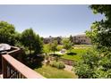 Scenic backyard view overlooking a lush green space, trees, and neighboring homes at 2214 E 101St Ave, Thornton, CO 80229