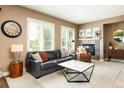 Inviting living room with a fireplace, comfortable seating, neutral tones, and ample natural light at 2214 E 101St Ave, Thornton, CO 80229
