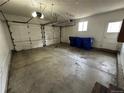 Spacious two car garage with white doors, storage space, and blue recycling bins at 11306 E Colorado Dr, Aurora, CO 80012