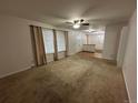 Inviting living room with natural lighting, neutral walls and carpet at 11306 E Colorado Dr, Aurora, CO 80012
