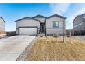 Charming home with a spacious driveway, low-maintenance front yard, and attached two-car garage at 2404 Horse Shoe Cir, Fort Lupton, CO 80621