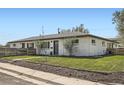 Charming home featuring a white brick facade, well-maintained lawn, and a neatly landscaped front yard at 1087 Wolff St, Denver, CO 80204