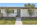 Charming home featuring a white brick facade, well-maintained lawn, and a neatly landscaped front yard at 1087 Wolff St, Denver, CO 80204