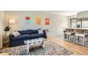 Inviting living room featuring stylish decor, a comfortable sofa, and an open layout to the kitchen at 1087 Wolff St, Denver, CO 80204