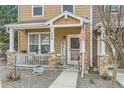 Inviting front porch featuring stone accents and a 'Welcome' sign, creating a warm entry at 15612 E 96Th Way # 29A, Commerce City, CO 80022