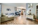 Spacious living room with hardwood floors, a fireplace, and stylish decor, perfect for relaxation at 15612 E 96Th Way # 29A, Commerce City, CO 80022