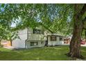 A charming two-story home with a lush green lawn and mature trees at 3545 Moorhead Ave, Boulder, CO 80305