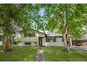 Charming two-story home with beautifully landscaped front yard and mature trees at 3545 Moorhead Ave, Boulder, CO 80305