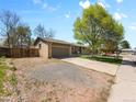 Charming single-story home featuring a well-maintained lawn, large shade tree and an attached two-car garage at 4779 S Owens Way, Littleton, CO 80127