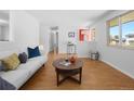 Comfortable living room with a white sofa, bright red front door, and open design at 4779 S Owens Way, Littleton, CO 80127