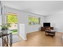 Bright living room featuring a large window, hardwood floors, and a welcoming entrance at 4779 S Owens Way, Littleton, CO 80127