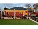 Cozy backyard patio with pergola, seating, and artificial turf at 2686 Poplar St, Denver, CO 80207