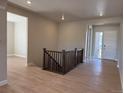 Inviting foyer with wood floors and an elegant staircase leading to the upper level of the home at 16655 W 93Rd Pl, Arvada, CO 80007