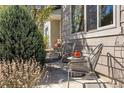 Inviting front porch featuring comfortable seating area and manicured shrubbery at 1857 W 67Th Pl, Denver, CO 80221