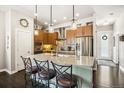 Stylish kitchen boasts a large island with bar seating, stainless appliances, and ample cabinet space at 1857 W 67Th Pl, Denver, CO 80221