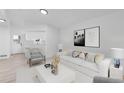 Bright living room with white walls, modern furniture, and stylish decor at 4552 S Buckley Way, Aurora, CO 80015