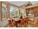 Cozy dining area with large windows showcasing the outdoor view and a stylish light fixture at 481 Sunrise Dr, Golden, CO 80401