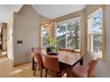 Bright dining area with large windows, a modern chandelier, and comfortable seating for Gathering meals at 481 Sunrise Dr, Golden, CO 80401