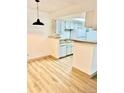 Bright dining area with wood flooring adjacent to the kitchen at 4400 S Quebec St # 102R, Denver, CO 80237