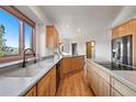 Bright kitchen with granite countertops, wood cabinetry, stainless steel appliances, and a scenic view at 29011 Upper Moss Rock Rd, Golden, CO 80401