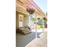 Back patio area, complete with comfortable seating and decorative hanging flowers at 4520 S Delaware St, Englewood, CO 80110