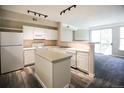 Well-lit kitchen boasts essential appliances, light countertops, island, and an open design at 2162 Concord Ln, Superior, CO 80027
