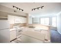 Bright kitchen includes modern appliances, light countertops, island, and stylish lighting at 2162 Concord Ln, Superior, CO 80027