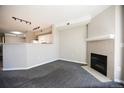 Cozy living room features neutral walls, carpeting, fireplace, and an open kitchen at 2162 Concord Ln, Superior, CO 80027