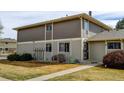 Exterior view of a two-story townhome featuring a well-manicured lawn at 6650 E Arizona Ave # 138, Denver, CO 80224