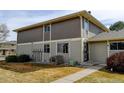 View of a two-story townhome featuring a well-manicured lawn and sidewalk at 6650 E Arizona Ave # 138, Denver, CO 80224