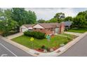 Corner lot featuring a well-maintained lawn and a detached garage, providing ample space and convenience at 920 Emerson Cir, Northglenn, CO 80233