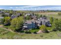 Aerial view of a lovely home in a beautiful community with rolling hills and open spaces at 9728 Ashleigh Ln, Highlands Ranch, CO 80126