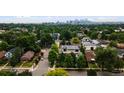 This home offers city skyline views amid lush greenery and neighborhood charm at 3690 W Byron Pl, Denver, CO 80211