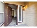 Open doorway revealing a bright condo interior with tiled entry and view into the living space at 4875 S Balsam Way # 6-102, Littleton, CO 80123